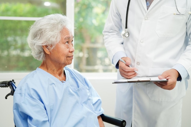 Doctor checking and note diagnosis medicine in clipboard of patients in hospital