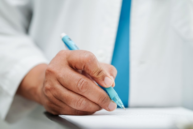 Doctor checking and note diagnosis medicine in clipboard of patients in hospital