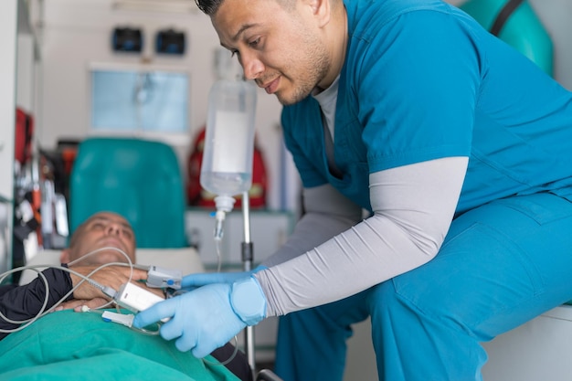 Doctor checking a patient's pulse in an ambulance