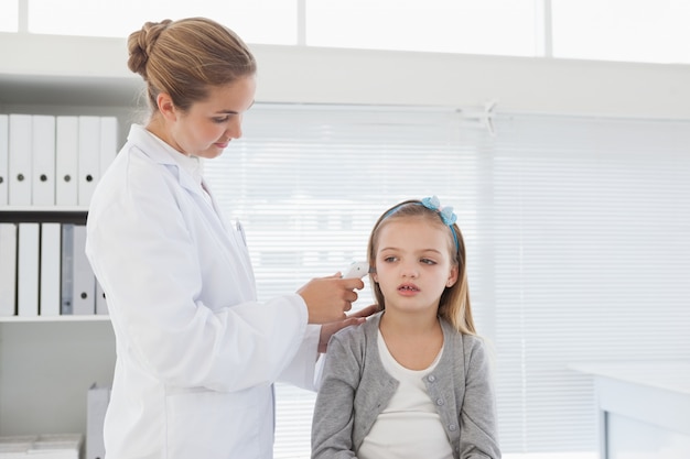 Doctor checking patients ear