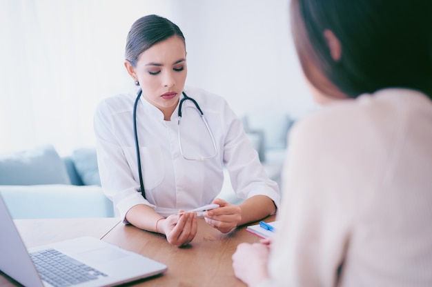 Doctor checking temperature to patient in the hospital