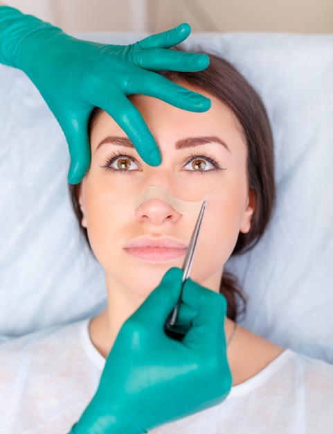 Doctor checking woman's face, the eyelid before plastic surgery, blepharoplasty. 