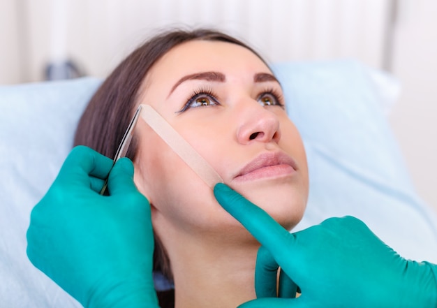 Doctor checking woman's face, the eyelid before plastic surgery, blepharoplasty. 