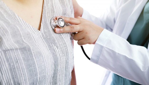 Doctor checks body by stethoscope