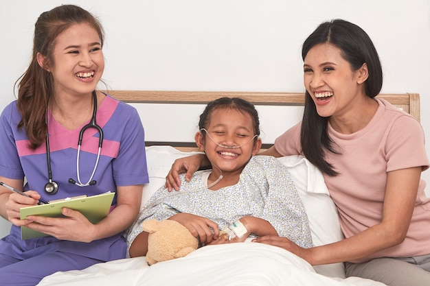 Doctor and child with mother in hospital