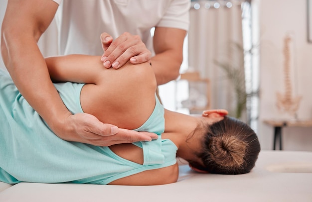 Doctor chiropractor and woman with back pain for physiotherapy from a physiotherapist helping with spine alignment Rehabilitation and chiropractic worker healing a healthy girls spinal posture