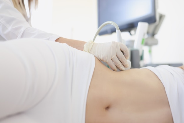 Photo doctor conducts ultrasound examination of internal organs