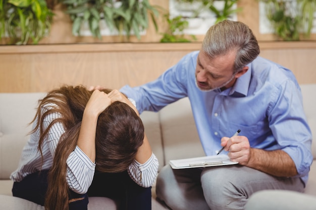 Doctor consoling female patient