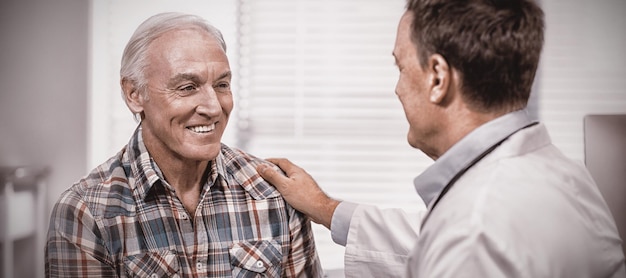 Doctor consoling senior man