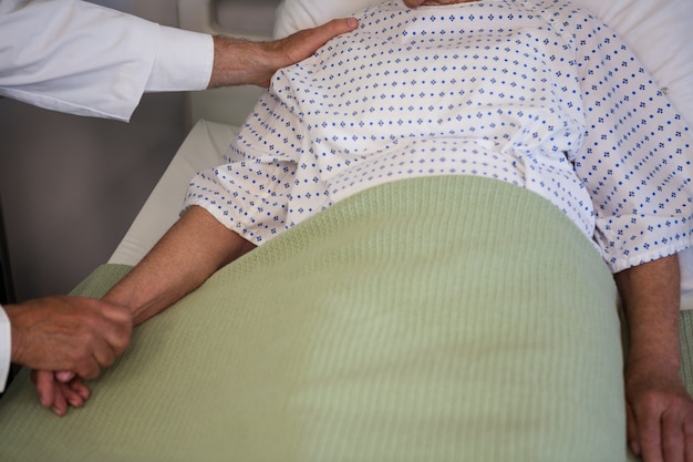 Doctor consoling senior patient