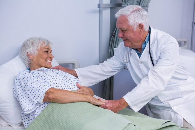 Doctor consoling senior patient