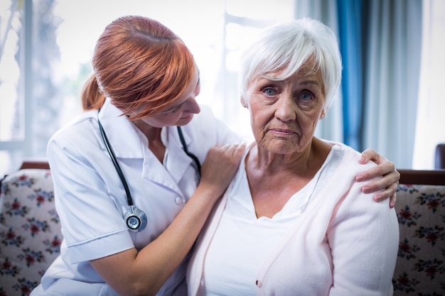 Doctor consoling senior woman