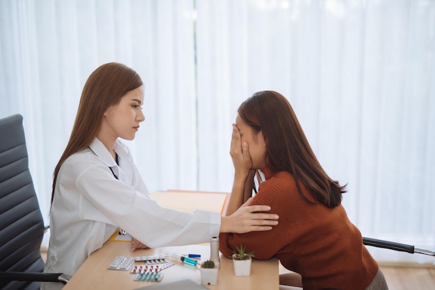doctor consoling worried patient at hospital