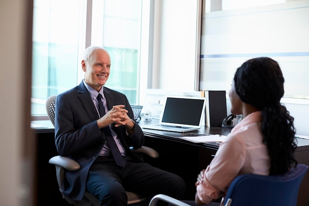 Doctor In Consultation With Female Patient In Office