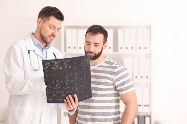 Doctor consulting male patient in clinic