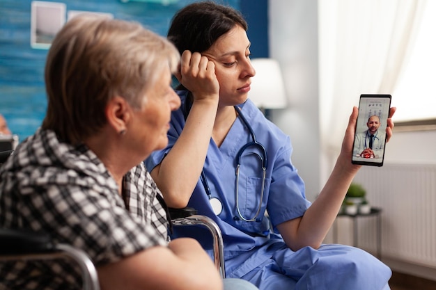 Photo doctor consulting patient on video call