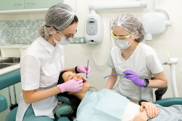 Doctor dentist doing medical stomatology examination for woman patient using professional tools