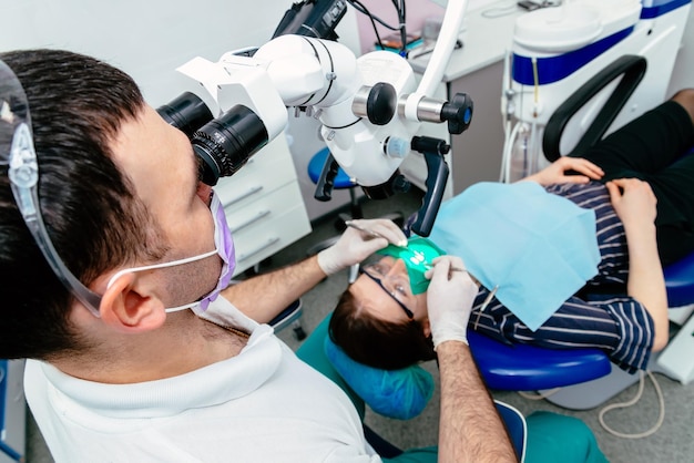 Doctor dentist uses a microscope