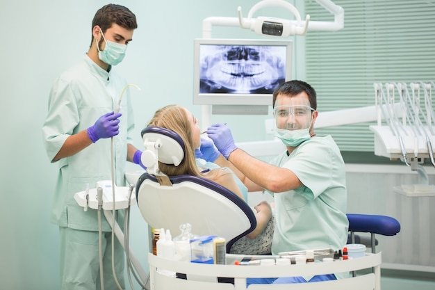 Doctor Dentist with an assistant work in a dental clinic.