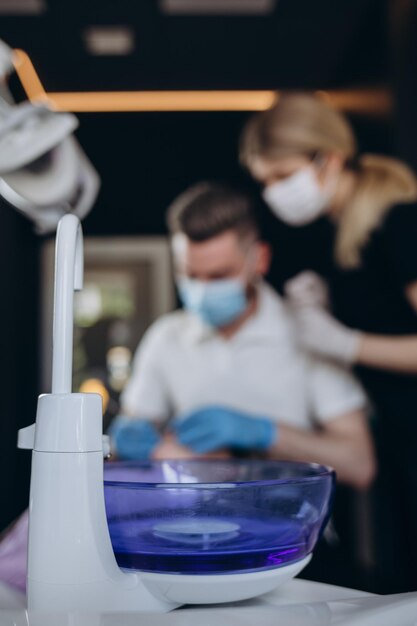 Doctor Dentist with an assistant work in a dental clinic