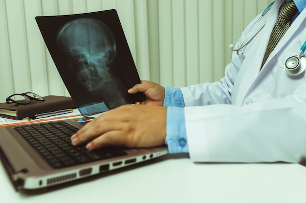 Doctor diagnose and analyze on x-ray film of patient