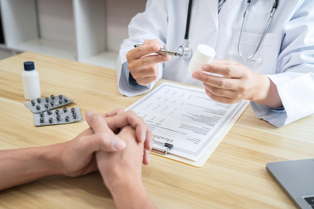 Doctor discussing with the patient using the medicine something and recommend treatment methods, Presenting results on report, Medicine and Healthcare concept.