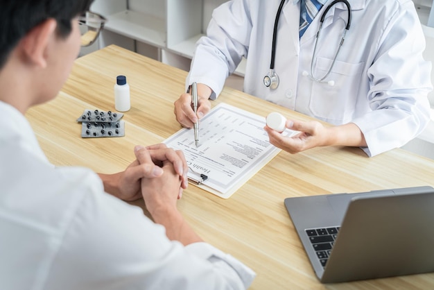 Doctor discussing with the patient using the medicine something and recommend treatment methods, Presenting results on report, Medicine and Healthcare concept.