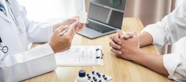 Photo doctor discussing with the patient using the medicine something and recommend treatment methods presenting results on report medicine and healthcare concept