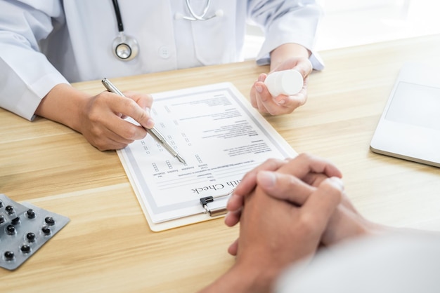 Photo doctor discussing with the patient using the medicine something and recommend treatment methods presenting results on report medicine and healthcare concept