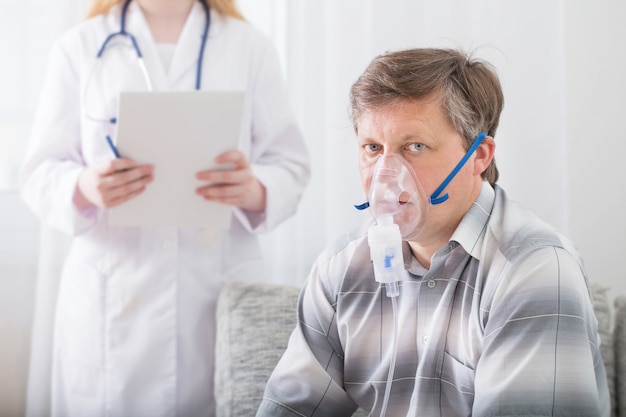 Doctor does inhalation  man