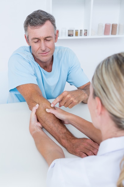 Doctor doing arm massage in medical office