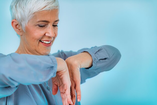 Doctor doing medical exam with senior woman checking for carpal tunnel syndrome