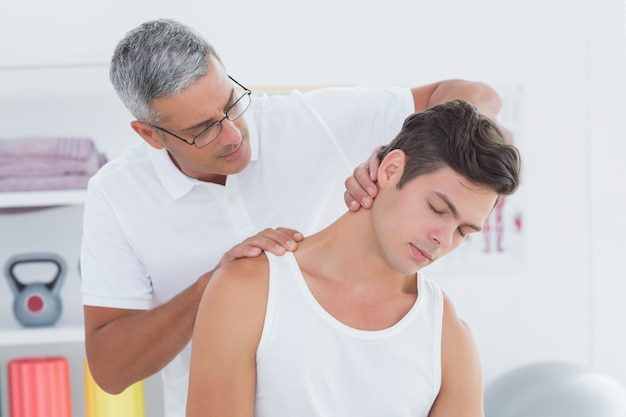 Doctor doing neck adjustment