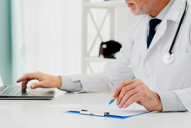 Photo doctor doing research on his laptop