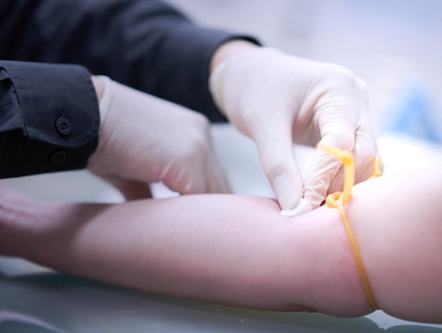 Doctor draw blood fron vein of patient for test diagnosis