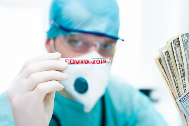 doctor epidemiologist with coronavirus test tube