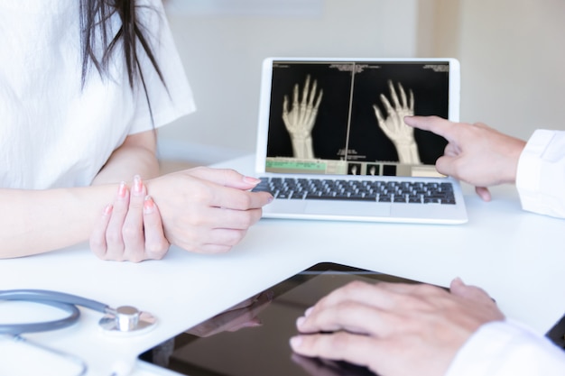 The doctor examined the patient with wrist pain And x-ray hand