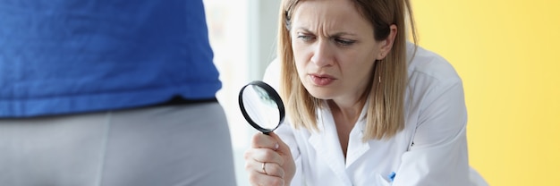 Doctor examines male organs through magnifying glass male\
urinary problems