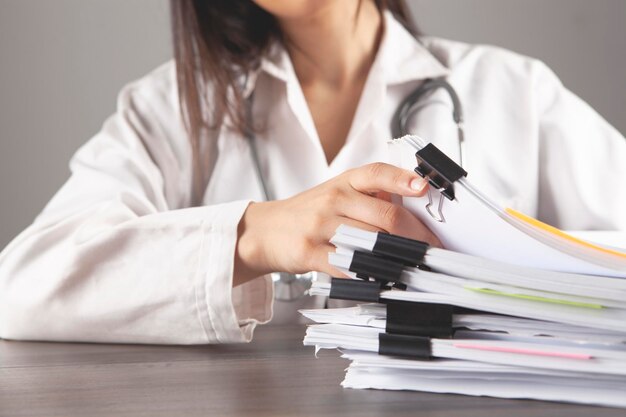 The doctor examines the papers at the table