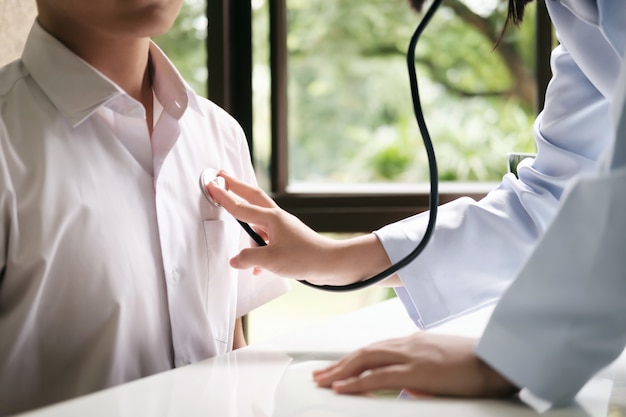 Doctor examines a patient with a stethoscope.