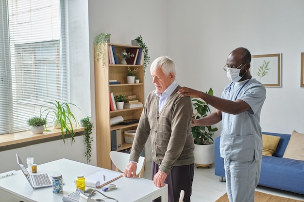 Doctor examining the elderly man