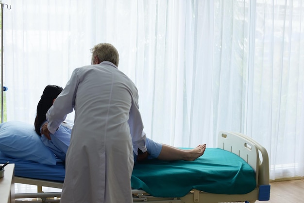 Doctor examining female patient at hospital