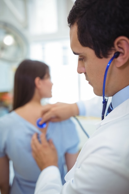 Doctor examining a female patient