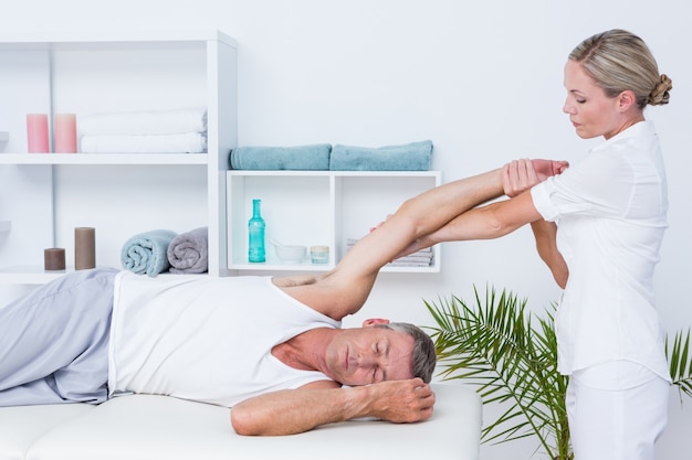 Doctor examining her patient arm