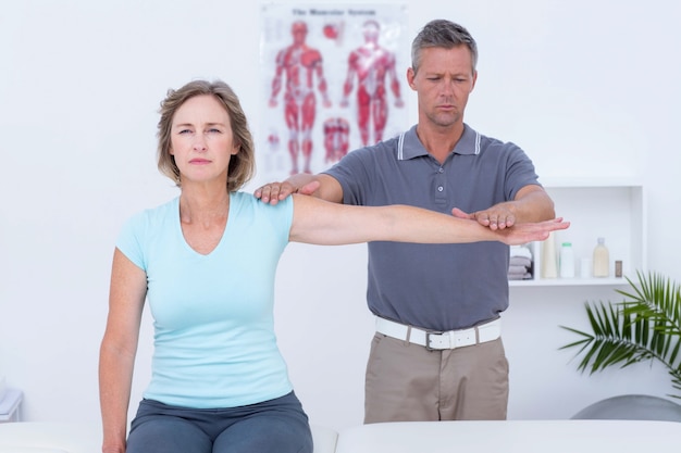 Doctor examining his patient arm