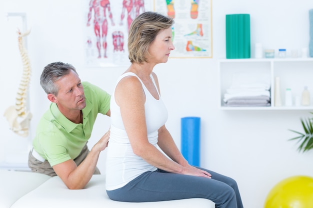 Doctor examining his patient back in medical office