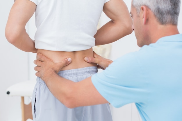 Doctor examining his patient back 