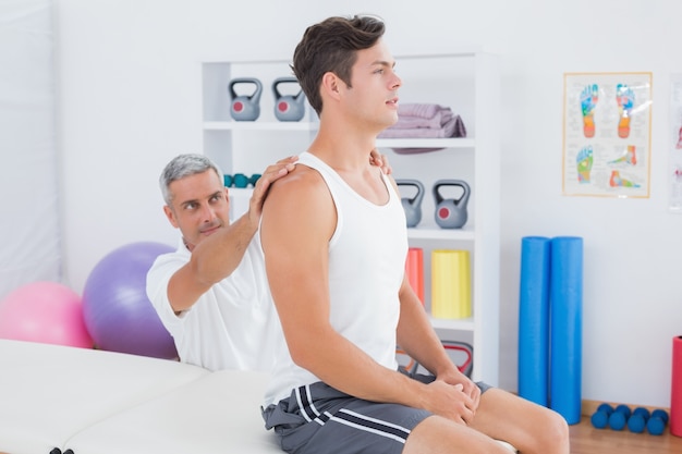 Doctor examining his patient back 