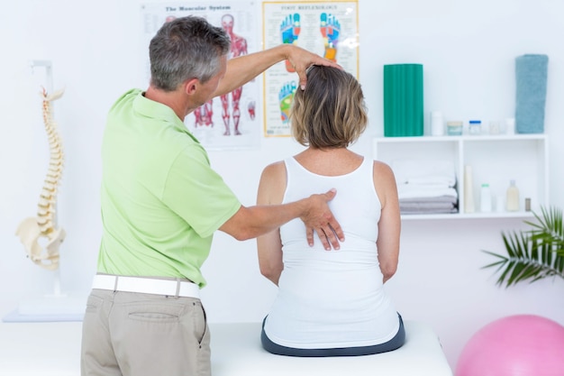 Photo doctor examining his patient back