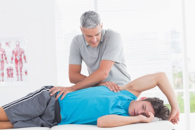 Doctor examining his patient back